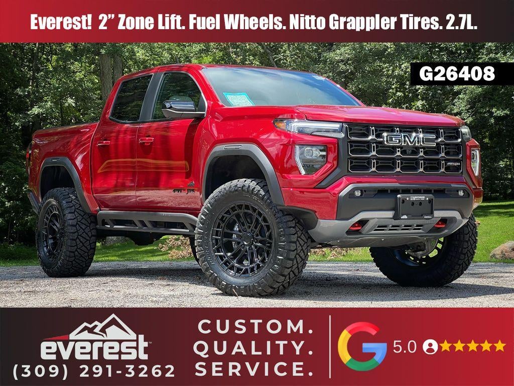 2026 GMC Canyon 4WD AT4X in Volcanic Red Tintcoat — front three-quarter view