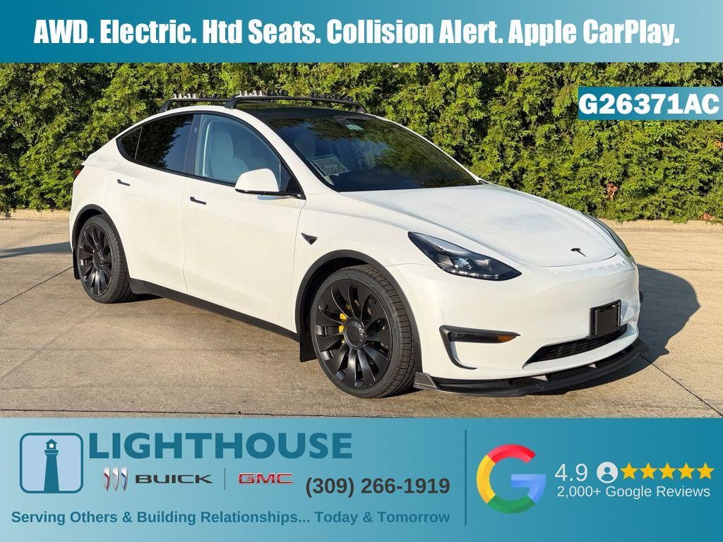 2024 Tesla Model Y Performance in White — front three-quarter view